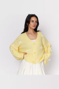 Cárdigan oversize con lacitos en amarillo con lazos blancos